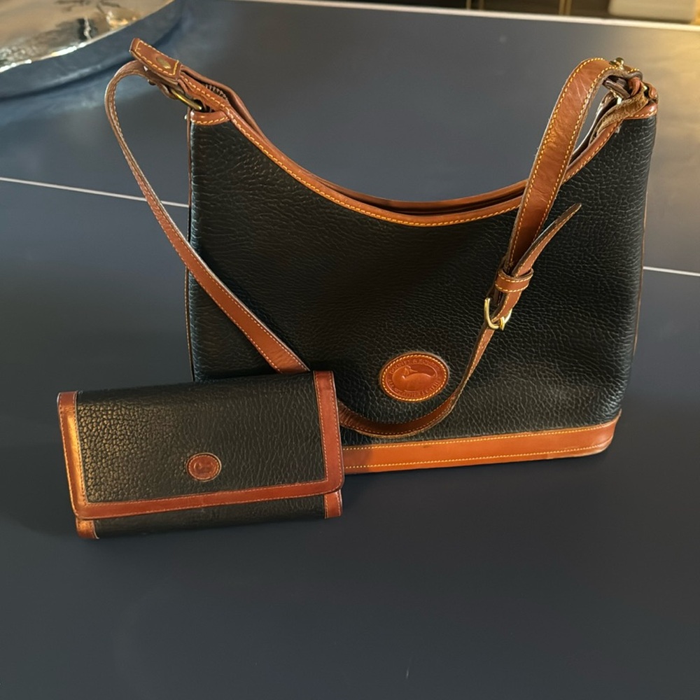 Dooney and Bourke, navy & caramel purse & matching wallet. Great used condition.